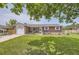 Charming brick ranch-style home featuring a well-manicured lawn and inviting front porch at 10633 E 6Th Pl, Aurora, CO 80010