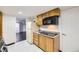 Compact kitchen offers essential appliances and wooden cabinetry, providing a functional cooking space at 10633 E 6Th Pl, Aurora, CO 80010
