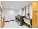 Bright laundry area features a gray, front-loading washer and dryer, complemented by a utility sink for added convenience at 10633 E 6Th Pl, Aurora, CO 80010