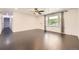 Spacious living room with sleek, dark hardwood floors and neutral walls at 10633 E 6Th Pl, Aurora, CO 80010