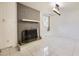 Cozy living room featuring a grey brick fireplace, white mantel, and tile flooring at 10633 E 6Th Pl, Aurora, CO 80010