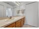 Bathroom featuring a single sink vanity, mirror, and towel rack at 5139 W 73Rd Ave, Westminster, CO 80030