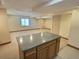 Spacious basement area with neutral carpeting featuring drop ceiling with recessed lighting at 10553 Adams St, Northglenn, CO 80233