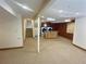 Finished basement area featuring washer and dryer hook ups, neutral carpet and stairs to other level of home at 10553 Adams St, Northglenn, CO 80233
