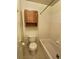 Bathroom with toilet, tub/shower, and cabinet space for storage, with basic neutral finishes at 10553 Adams St, Northglenn, CO 80233
