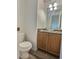 Well-lit half bathroom with a unique glass bowl sink and wood-look flooring at 10553 Adams St, Northglenn, CO 80233