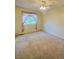 Standard bedroom featuring neutral carpeting and a window with light filtering curtains and an overhead ceiling fan with lighting at 10553 Adams St, Northglenn, CO 80233