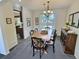 Cozy dining room featuring a wooden table and chairs, cabinet, and window at 10553 Adams St, Northglenn, CO 80233