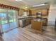 Functional kitchen featuring an island, stainless steel appliances, and access to the patio at 10553 Adams St, Northglenn, CO 80233