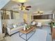 Bright living room with ceiling fan, plush seating, and decorative rug for a cozy and inviting atmosphere at 10553 Adams St, Northglenn, CO 80233