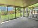 Glass enclosed sunroom with sliding doors leading to backyard and views of lawn at 10553 Adams St, Northglenn, CO 80233