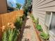 Landscaped yard featuring stone walkway, plants and flowers, and wooden fence at 10553 Adams St, Northglenn, CO 80233
