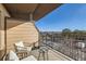 A cozy balcony featuring patio furniture and views of the surrounding neighborhood at 15475 Andrews Dr # 318, Denver, CO 80239