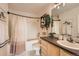 Bathroom featuring a shower-tub combo, framed mirror, and stylish decor at 15475 Andrews Dr # 318, Denver, CO 80239