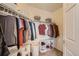 A walk-in closet featuring ample hanging space, shelving, and a laundry basket at 15475 Andrews Dr # 318, Denver, CO 80239