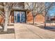 Condominium entrance with secure door, sidelights and trees in sidewalk tree wells at 15475 Andrews Dr # 318, Denver, CO 80239