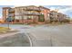 Condominium complex featuring brick and painted siding with private balconies and beautiful architectural details at 15475 Andrews Dr # 318, Denver, CO 80239