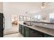 Updated kitchen features dark green cabinets and black appliances at 15475 Andrews Dr # 318, Denver, CO 80239