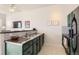 Modern kitchen featuring dark green cabinets and stainless steel appliances at 15475 Andrews Dr # 318, Denver, CO 80239