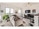 Bright living room featuring modern decor, a comfortable sofa, large windows and a ceiling fan at 15475 Andrews Dr # 318, Denver, CO 80239