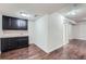 Spacious basement area with modern cabinetry, a sink, and durable hardwood flooring at 6634 S Patsburg St, Aurora, CO 80016
