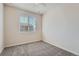 Cozy bedroom featuring plush carpeting, neutral walls, and a ceiling fan at 6634 S Patsburg St, Aurora, CO 80016