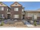 Charming townhome showcasing a well-maintained brick facade, stylish gray accents, and neat landscaping at 6634 S Patsburg St, Aurora, CO 80016