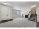 Bright living room featuring neutral decor, a fireplace, and a staircase leading to the upper level at 6634 S Patsburg St, Aurora, CO 80016