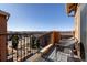 Outdoor balcony featuring wrought iron railing, a trellised ceiling, and seating that overlooks a lovely neighborhood at 9186 Viaggio Way, Highlands Ranch, CO 80126