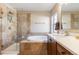 Bright bathroom featuring a glass enclosed shower, soaking tub, and dual sink vanity with plenty of natural light at 9186 Viaggio Way, Highlands Ranch, CO 80126