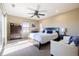 Bright bedroom with a ceiling fan, large bed, and sliding doors to a balcony at 9186 Viaggio Way, Highlands Ranch, CO 80126