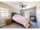 Comfortable bedroom with a ceiling fan, a large bed, and two windows offering natural light at 9186 Viaggio Way, Highlands Ranch, CO 80126