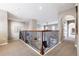 Second-floor hallway with decorative wrought iron railing overlooking the living room at 9186 Viaggio Way, Highlands Ranch, CO 80126