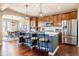 Kitchen features a large island with bar seating, modern appliances, and an adjacent dining area at 9186 Viaggio Way, Highlands Ranch, CO 80126