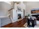 Inviting living room boasts a fireplace and staircase, creating a warm and welcoming atmosphere at 9186 Viaggio Way, Highlands Ranch, CO 80126