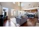 Bright living room boasts hardwood floors, a vaulted ceiling, and seamless flow into a modern kitchen at 9186 Viaggio Way, Highlands Ranch, CO 80126