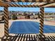 View of neighborhood and mountains beyond a covered pool at 9186 Viaggio Way, Highlands Ranch, CO 80126