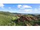 Picturesque aerial view of the unique red rock landscape and a nearby estate home at 3755 N Rampart Range Rd, Littleton, CO 80125