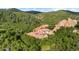 Breathtaking aerial view showcasing a grand estate nestled within a lush, green landscape at 3755 N Rampart Range Rd, Littleton, CO 80125
