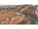 Spectacular aerial perspective of a luxurious home integrated within a dramatic red rock landscape at 3755 N Rampart Range Rd, Littleton, CO 80125