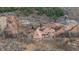 Stunning aerial view of a secluded home nestled among red rock formations and lush greenery at 3755 N Rampart Range Rd, Littleton, CO 80125