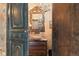 Bathroom with a chandelier, wooden vanity, and a stone vessel sink, as seen through a doorway at 3755 N Rampart Range Rd, Littleton, CO 80125