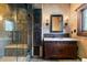 Modern bathroom featuring glass shower, vessel sink, and antique wooden accents at 3755 N Rampart Range Rd, Littleton, CO 80125