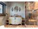 Charming bathroom with decorative vanity, stone vessel sink, and tiled shower at 3755 N Rampart Range Rd, Littleton, CO 80125