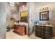 Luxurious bathroom with copper tub, modern vanity, and elegant lighting at 3755 N Rampart Range Rd, Littleton, CO 80125