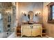 Elegant bathroom featuring a decorative vanity, vessel sink, and tiled shower at 3755 N Rampart Range Rd, Littleton, CO 80125