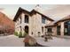 Beautiful stone house with arched balconies, tile roof, and well-manicured landscaping at 3755 N Rampart Range Rd, Littleton, CO 80125