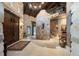 Grand foyer with stone walls, high ceilings, wooden doors, and a staircase leading to the upper level at 3755 N Rampart Range Rd, Littleton, CO 80125