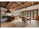 Gourmet kitchen with brick flooring, wood island, wooden beams and a wall of windows at 3755 N Rampart Range Rd, Littleton, CO 80125