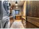 Well-appointed laundry room with wooden cabinetry, laundry machines, and tile flooring at 3755 N Rampart Range Rd, Littleton, CO 80125
